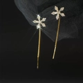 Close-up of elegant gold snowflake tassel earrings with zircon stones on black background - Crystal Flower Ear Line - Gold