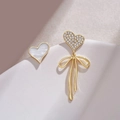 Detailed view of asymmetric S925 silver heart earrings with bow and mother of pearl inlay - Asymmetric Mother Of Pearl Heart Drop Earrings