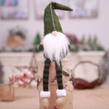 Christmas faceless gnome plush in green striped legs sitting on wooden prop decor - Green