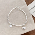 Makroaufnahme des S925-Stempels am Herzanhänger mit geometrischem Perlenarmband - Geometrischer Würfel Herz Armband / Silber