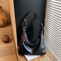 Matte black leather hobo shoulder bag with a brown spiral charm and gold hardware - With Pendant / Black