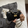 Black quilted crossbody bag with gold chain strap and plush puppy charm detail - Black With Pendant
