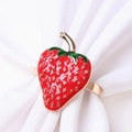 Close-up of strawberry napkin ring with red enamel finish and gold seed details - Gold