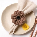 Brown fabric flower napkin ring with fringe petals and bead center on linen napkin - Light Coffee