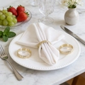 Elegant gold-plated textured metal napkin ring set on a white plate with white napkin - Hammered Texture Small Ring (ZWZ-RNP-699) / Gold