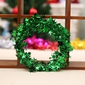 7.5m green Christmas star tinsel garland with metallic glitter on a festive wooden background - Green