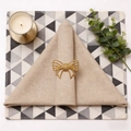 Golden butterfly napkin ring with textured metal finish on an elegant dining table set - Bow Style / Gold
