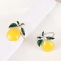 Detailed macro view of metal lemon napkin rings with vibrant yellow enamel finish - Lemon Yellow