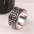 Classic silver alloy napkin ring with Greek meander pattern in a 45-degree side view - Antique Silver