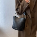 Classic black vintage bucket bag in textured faux leather with gold fashion lettering - Black