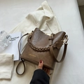 Brown bucket bag in textured faux leather with woven handle and gold fashion lettering - Khaki
