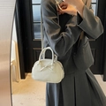 Elegant ivory white crossbody bowling bag with a chic bow decoration and top handle - Off White