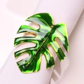 Macro detail of green monstera leaf napkin ring with golden metallic finish and enamel glaze - Iron Gold and Green