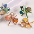 Portatovaglioli a forma di stella marina e conchiglia con strass colorati e perle - Oro