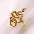 Golden snake napkin ring with detailed scale texture on white pleated fabric backdrop - Snake / Gold