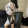 Minimalist black lychee leather tote bag with geometric silk scarf on shoulder - Black