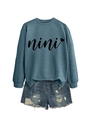 Detail showing nini heart print on casual blue crewneck sweatshirt with denim shorts - S / Blue (Black Font)