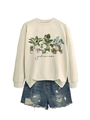 Flat lay of beige crewneck sweatshirt with botanical print and frayed denim shorts - Sand Sweatshirt (Black Text)