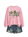 Flat lay of a pink sweatshirt featuring plant illustrations and frayed denim shorts - Pink Sweatshirt (Black Text)