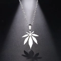 Detailed close-up of maple leaf pendant on chain with sharp lighting and shadows - Silver (N218)