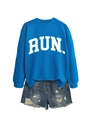 Detail of royal blue sweatshirt with white RUN print and distressed denim shorts - Lake Blue (White Font)