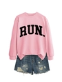 Flat lay of pink RUN letter sweatshirt paired with distressed denim shorts - Pink (Black Font)
