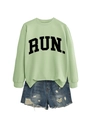 Close-up of light green sweatshirt with RUN letter print and distressed denim shorts - Olive Green (Black Font)