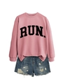 Close-up of pink crewneck sweatshirt with RUN text and distressed denim shorts - Rose Gold (Black Font)
