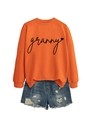 Close-up of granny script and heart print on bright orange crewneck sweatshirt - Orange (Black Font)