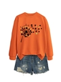 Detail of clover dandelion print and lucky typography on an orange long-sleeve sweatshirt - Orange (Black Letters)