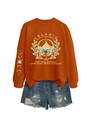 Flat lay of Velaris starlight hoodie with moon phase sleeve and ripped denim shorts - Burnt Orange
