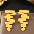 Macro shot of gold geometric zigzag stud earrings on a premium satin jewelry box - Gold (C1323)
