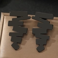 Detail of matte black geometric earrings with jagged wave design on brown satin padding - Black (C1323-BLACK)