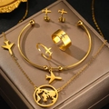 Golden travel jewelry set featuring airplane charms and world map pendant on brown box - Gold (C6727)