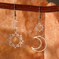 Bohemian silver sun and moon asymmetric earrings displayed on a natural branch - Silver Style (B1134)