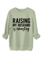 Close-up of olive green sweatshirt with Raising My Husband print and ribbed neckline - S / Olive Green