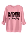 Close-up of pink crewneck sweatshirt featuring black 'RAISING MY HUSBAND' slogan print - S / Peach