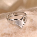 Adjustable silver heart ring with a concave design on a textured stone display - Silver Style (C3364)