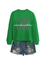 Close-up of bright green sweatshirt featuring CARE coordinator print and distressed denim shorts - S / Grass Green (White Print)
