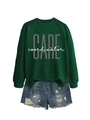 Flat lay of dark green sweatshirt with CARE print and distressed denim shorts - Dark Green (White Print)