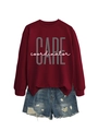 Close-up of a maroon pullover sweatshirt with CARE coordinator print and ripped denim shorts - Wine Red (White Print)