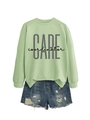 Detail of light green sweatshirt featuring grey CARE coordinator print and ribbed cuffs - Olive Green (Black Print)