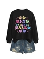 Detail of medical heart graphic print on black crewneck sweatshirt with blue denim shorts - Black