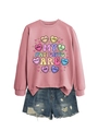 Flat lay of pink crewneck sweatshirt with heart print and distressed denim shorts - Rose Gold