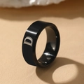 Polished black stainless steel signet ring featuring a textured letter D engraving - Letter D