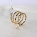 Spiral gold metal napkin ring with crystal beads on a white ceramic plate background - Gold Double Bead Spiral Style