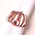 Close-up of rose gold pumpkin napkin ring with metallic finish for Halloween table decor - Shiny Rose Gold Pumpkin Style