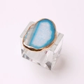 Elegant napkin ring with blue agate slice and golden metallic edge on clear stand - Glass Ring