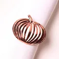 Macro detail of pumpkin shaped rose gold napkin ring with vertical hollow stripes - Rose Gold Hollow Out Striped Pumpkin Style