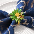 Golden flower napkin ring with green daisy and crystal bee on blue napkin fabric - Matcha Green